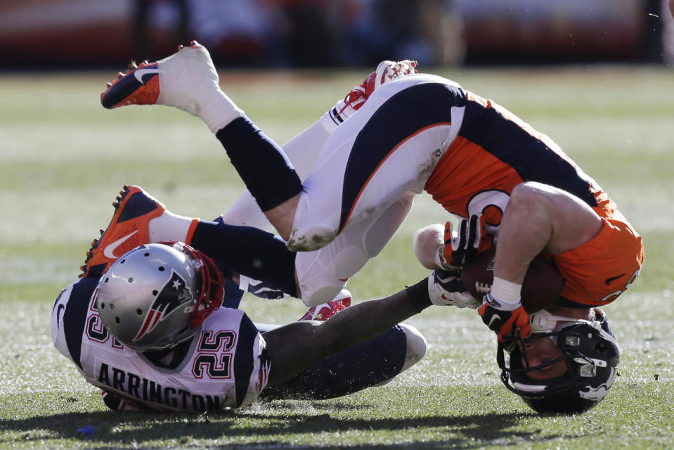 Denver Broncos wide receiver Wes Welker (83) is upended by New England Patriots cornerback Kyle Arrington (25) during the first half of the AFC Championship NFL playoff football game in Denver, Sunday, Jan. 19, 2014. (AP Photo/Julie Jacobson)