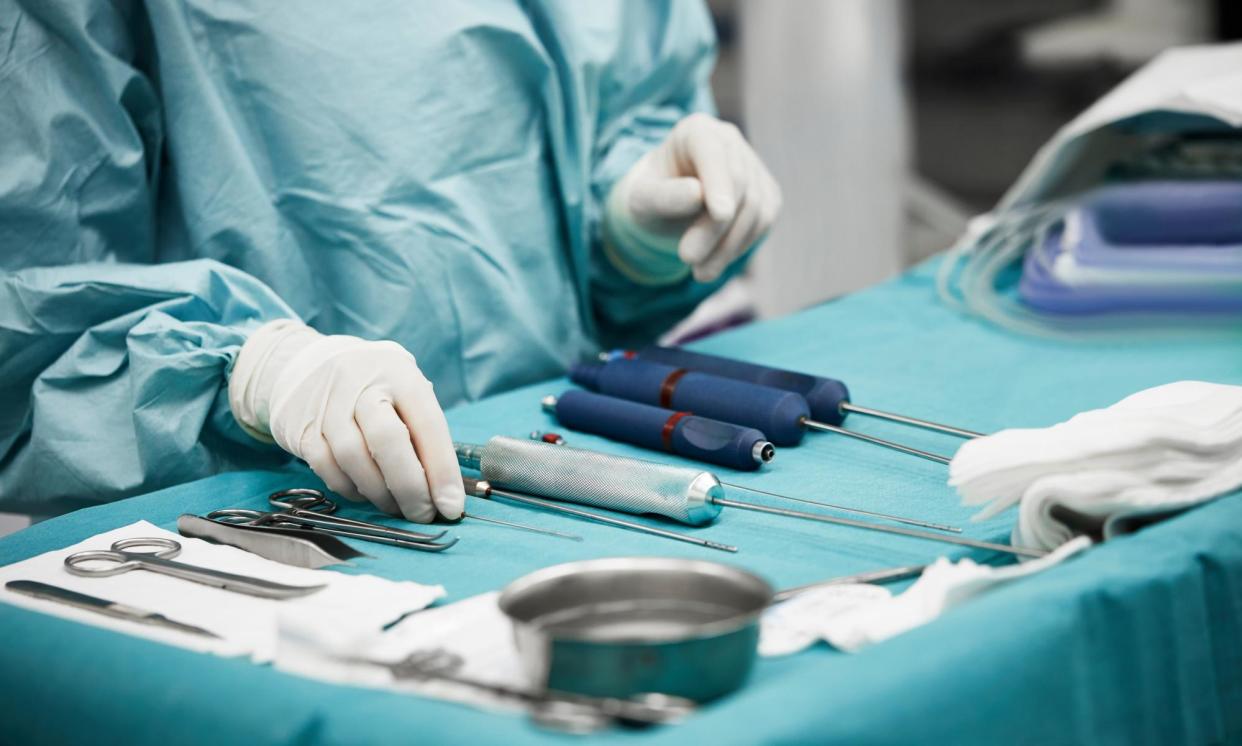 <span>Female doctor arranging surgical equipment.</span><span>Photograph: Morsa Images/Getty Images</span>