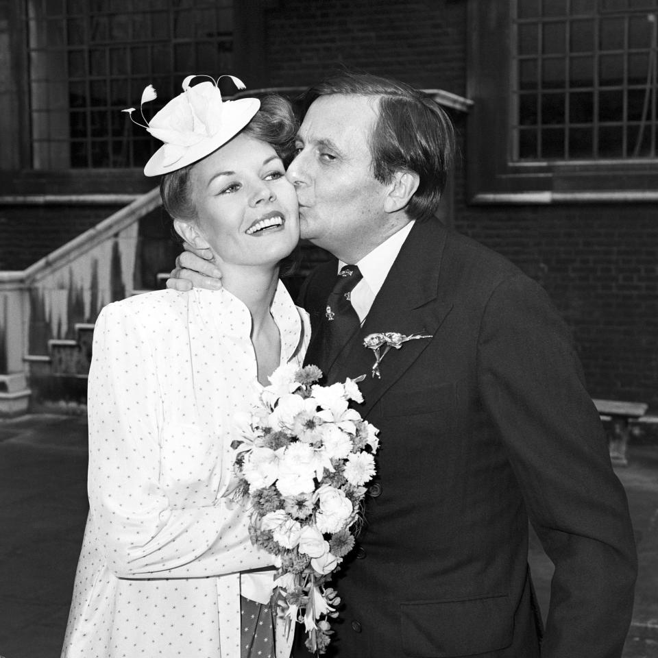 FILE - Actor Barry Humphries kisses his bride artist Diane Millstead, after their marriage had been blessed at St James's Church, Piccadilly, London, June 17, 1979. Tony Award-winning comedian Barry Humphries, internationally renowned for his garish stage persona Dame Edna Everage, a condescending and imperfectly-veiled snob whose evolving character has delighted audiences over seven decades, has died on Saturday, April 22, 2023, after spending several days in a Sydney hospital with complications following hip surgery, a Sydney hospital said. (PA via AP, File)