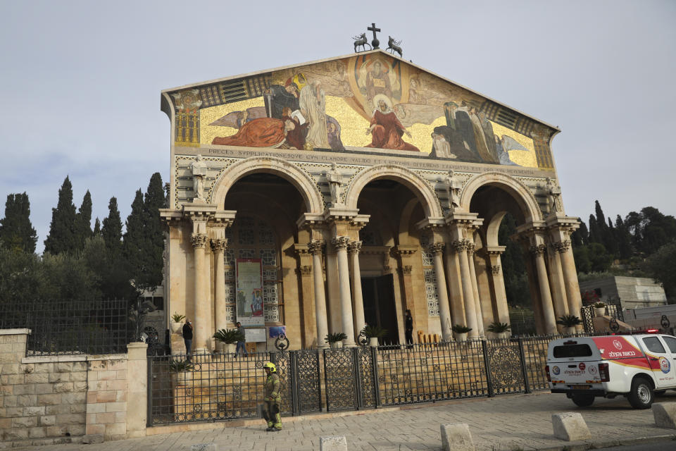 An firefighter stands outside the Church of All Nations in the Garden of Gethsemane, in east Jerusalem, Friday, Dec. 4, 2020. Israeli police said Friday they arrested a Jewish man after he poured out a "flammable liquid" inside a church near Jerusalem's Old City, in what they described as a "criminal" incident. (AP Photo/Mahmoud Illean)