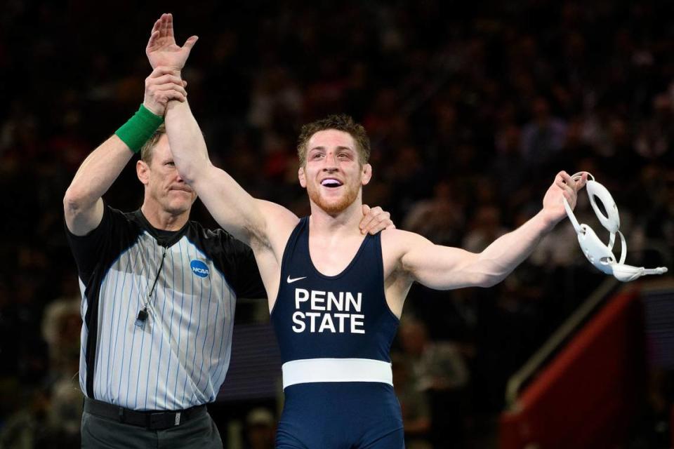 Penn State’s Nick Lee celebrates after defeating North Carolina’s Kizhan Clarke during their 141-pound match in the finals at the 2022 NCAA Division Wrestling Championships in Detroit, Saturday, March 19, 2022. (Andy Morrison/Detroit News via AP)