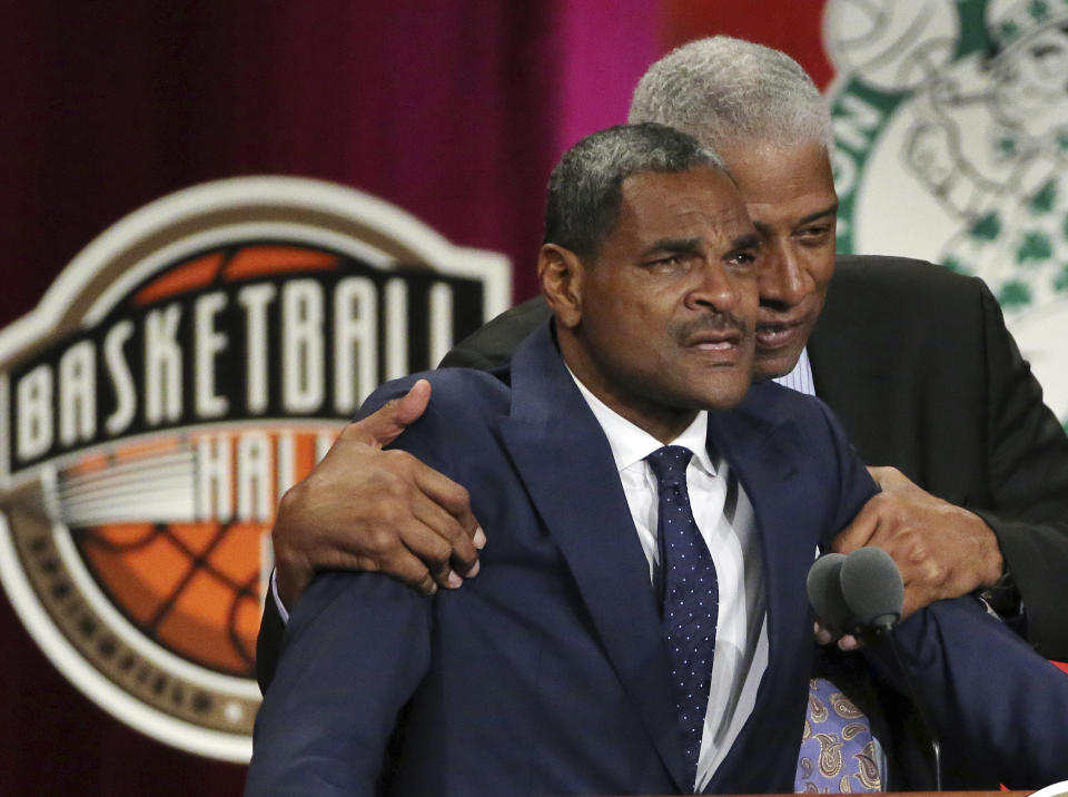 Inductee Maurice Cheeks, left, is hugged by Hall of Famer Julius Erving as he becomes emotional during his speech at the Basketball Hall of Fame, Friday, Sept. 7, 2018, in Springfield, Mass. (AP Photo/Elise Amendola)