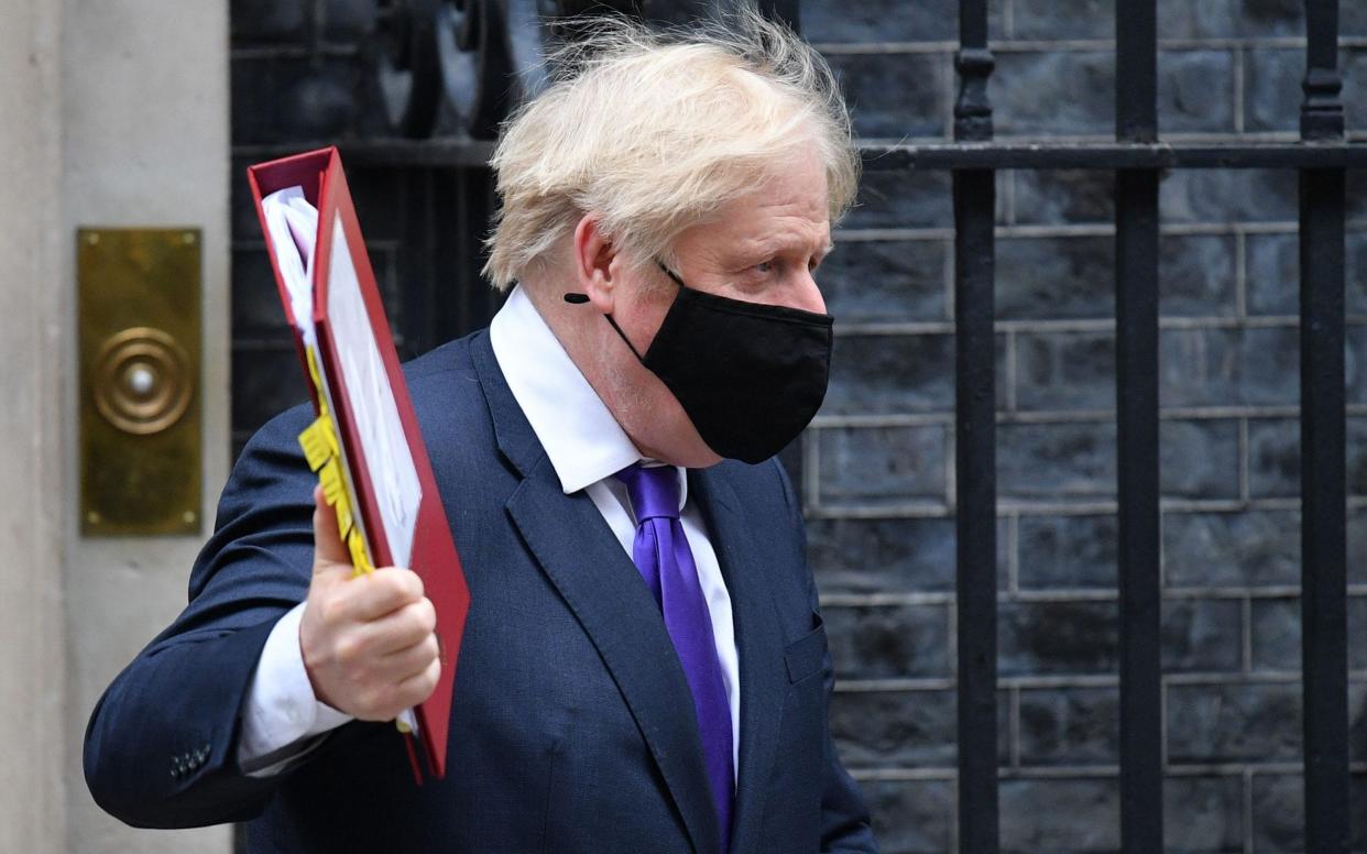 Britain's Prime Minister Boris Johnson wearing a face mask because of the coronavirus pandemic leaves number 10 Downing Street in central London  - JUSTIN TALLIS/AFP