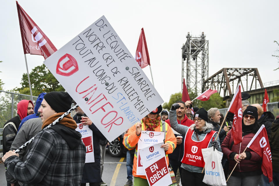 Striking St. Lawrence Seaway workers picket outside the St. Lambert Lock in St. Lambert, Quebec, Monday, Oct. 23, 2023. A strike has shut down all shipping on the St. Lawrence Seaway, interrupting exports of grain and other goods from Canada and the United States via the Great Lakes to the world. (Graham Hughes/The Canadian Press via AP)