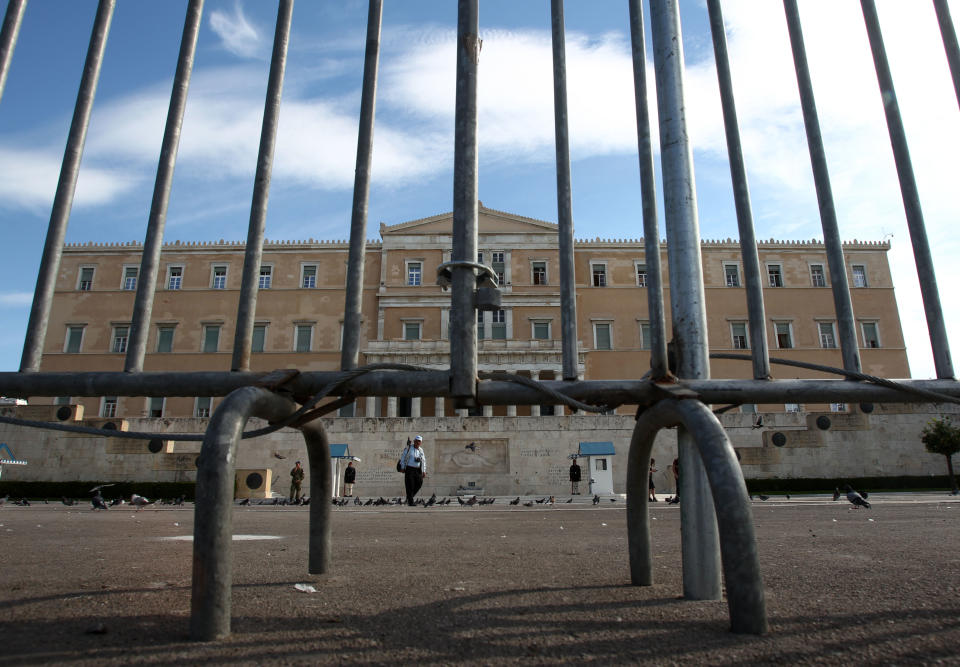 Police fences protect the Greek parliament, ahead of the 48-hour nationwide general strike of Tuesday and Wednesday, in central Athens, Monday, Nov. 5, 2012. Greece is facing three days of escalating anti-austerity strikes, with state hospital doctors, taxi drivers, transport workers and journalists walking off the job. The strikes come as the wobbly coalition government prepares to present another austerity package in Parliament later Monday. (AP Photo/Thanassis Stavrakis)