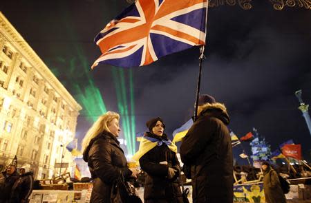 Pro-European integration protesters hold a British flag near a barricade during a rally at Independence Square in Kiev December 17, 2013. REUTERS/Marko Djurica