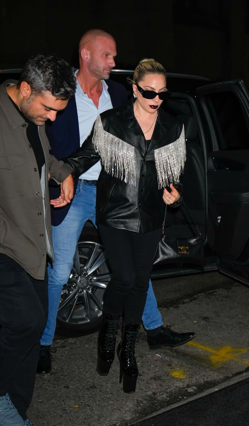 Lady Gaga in a leather jacket with fringe and diamond heels