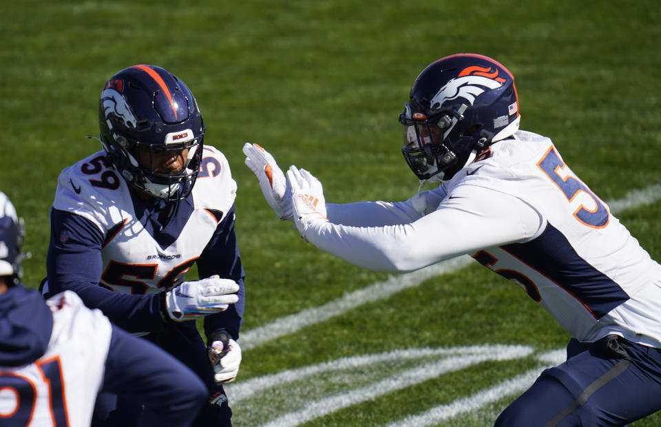 Denver Broncos outside linebackers Malik Reed, left, and Bradley Chubb take part in drills during an NFL football practice Wednesday, Oct. 28, 2020, at the team's headquarters in Englewood, Colo. (AP Photo/David Zalubowski)
