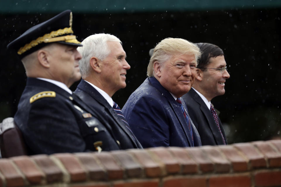 President Donald Trump participates in an Armed Forces welcome ceremony for the new chairman of the Joint Chiefs of Staff, Gen. Mark Milley, left, Monday, Sept. 30, 2019, at Joint Base Myer-Henderson Hall, Va. From left are Chairman of the Joint Chiefs of Staff, Gen. Mark Milley, Vice President Mike Pence, Trump and Secretary of Defense Mark Esper. (AP Photo/Evan Vucci)