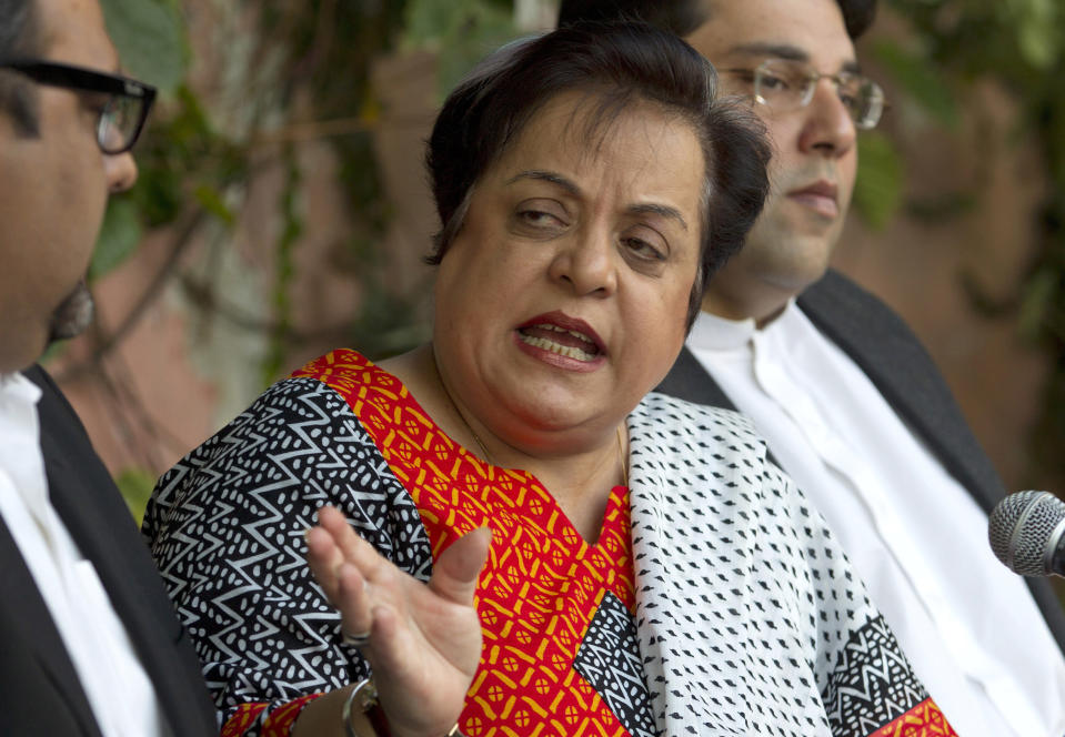 FILE - In this Wednesday, Nov. 27, 2013 file photo, Shireen Mazari, center, leader of the Pakistan Tehreek-e-Insaf party, addresses a news conference with party officials, in Islamabad, Pakistan. The government's Human Rights Minister Mazari said in a series of tweets. "Journalists do their job & to target them, especially gender-based abusive attacks on women journos, is absolutely unacceptable and disgusting,". Social media attacks against Pakistan's women journalists have been vile and vicious, some threatening rape, others even threatening death and the culprits are most often allied to the ruling party, even prompting the Committee to Protect Journalists to issue a statement on Friday condemning the relentless attacks. (AP Photo/B.K. Bangash, File)