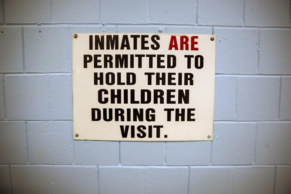 A sign on the wall of a visitation hub at the Rikers Island jail complex reads "Inmates Are Permitted to Hold Their Children During the Visit" at the facility in the Bronx borough of New York, on Tuesday, May 7, 2024. (AP Photo/Ted Shaffrey)