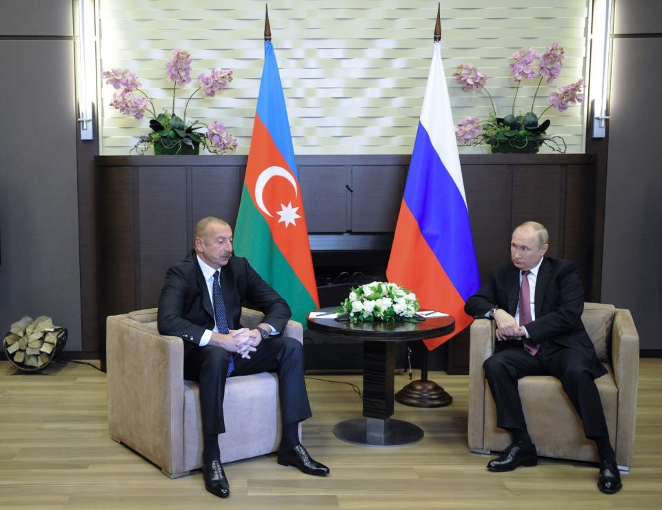 Russian President Vladimir Putin, right, and Azerbaijan's President Ilham Aliyev talk during their meeting in the Bocharov Ruchei residence in the Black Sea resort Sochi, Russia, Friday, Nov. 26, 2021. Russian President Vladimir Putin is hosting the leaders of Armenia and Azerbaijan for talks. The three are expected to discuss ways to resolve the tensions over the separatist region of Nagorno-Karabakh. (Mikhail Klimentyev, Sputnik, Kremlin Pool Photo via AP)