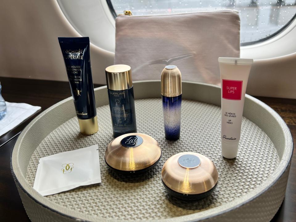 Guerlain skincare items laid out on a tray onboard a VistaJet Global 7500 at Farnborough Airport
