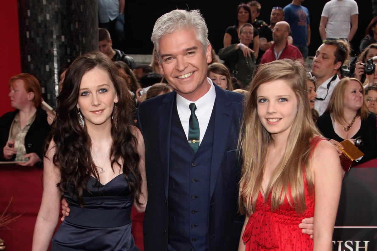 Molly and Ruby Schofield (L-R) have shown their allegiance to their father Phillip Scofield (Centre)  (Getty Images)