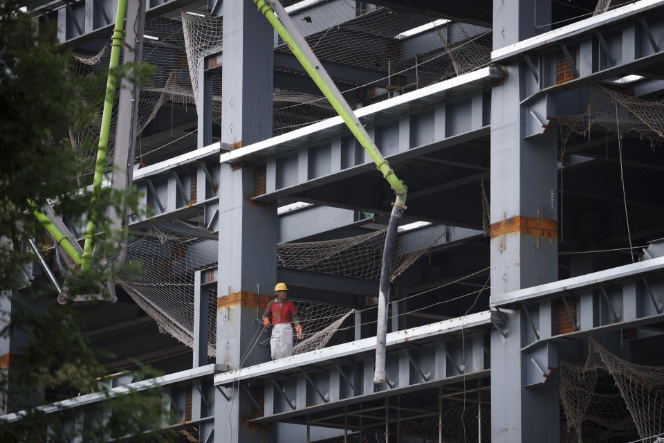 A construction worker labors in a site on the outskirts of Beijing, July 26, 2024. (AP Photo/Vincent Thian)