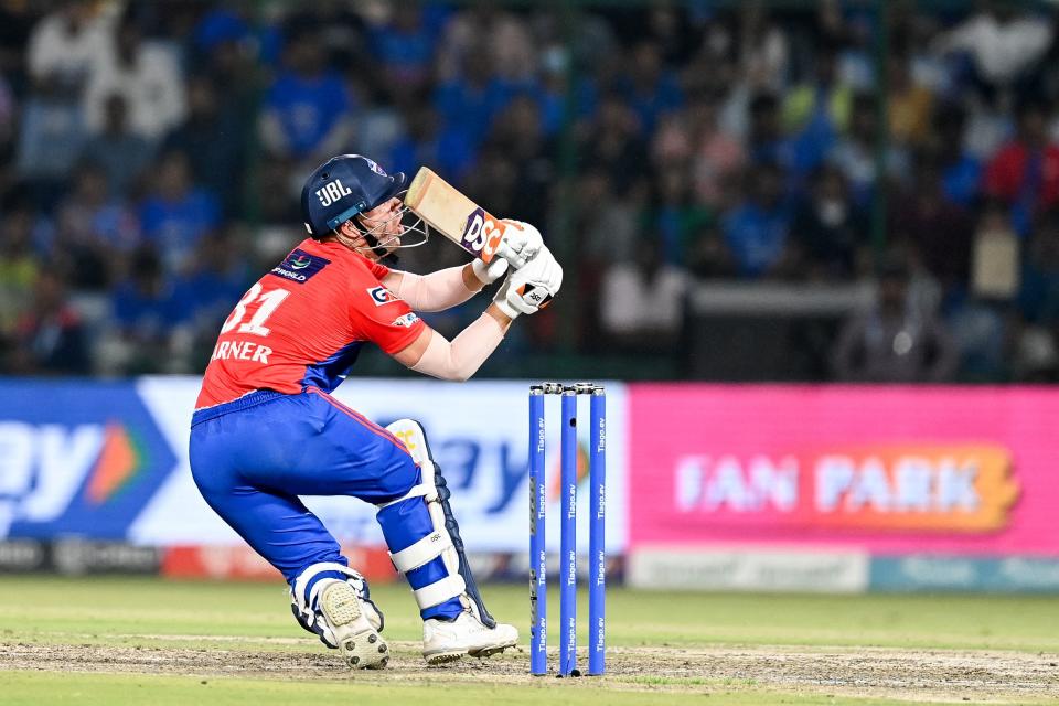 Delhi Capitals' David Warner watches the ball after playing a shot during the Indian Premier League (IPL) Twenty20 cricket match between Delhi Capitals and Mumbai Indians at the Arun Jaitley Stadium in New Delhi on April 11, 2023. (Photo by Sajjad HUSSAIN / AFP) (Photo by SAJJAD HUSSAIN/AFP via Getty Images)