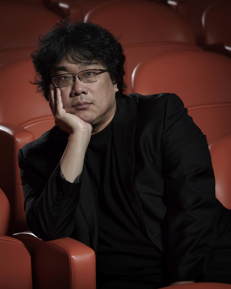 This Oct. 8, 2019 photo shows filmmaker Bong Joon-Ho posing for a portrait at the Whitby Hotel screening room in New York to promote his film "Parasite." The film will open in theaters Friday having already amassed $70.9 million in Bong's native South Korea. In May, "Parasite" won the Palme d’Or at the Cannes Film Festival, a first for a Korean film. (Photo by Christopher Smith/Invision/AP)