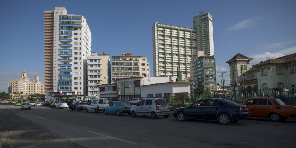 Vehicles wait in line to fill their gas tanks in Havana, Cuba, Thursday, Sept. 19, 2019. Lines this week have come to stretch for blocks with waits up to five hours long. Drivers park and shut off their cars to wait in the shade and chat with friends as cars crawl past pumps far in the distance. (AP Photo/Ismael Francisco)