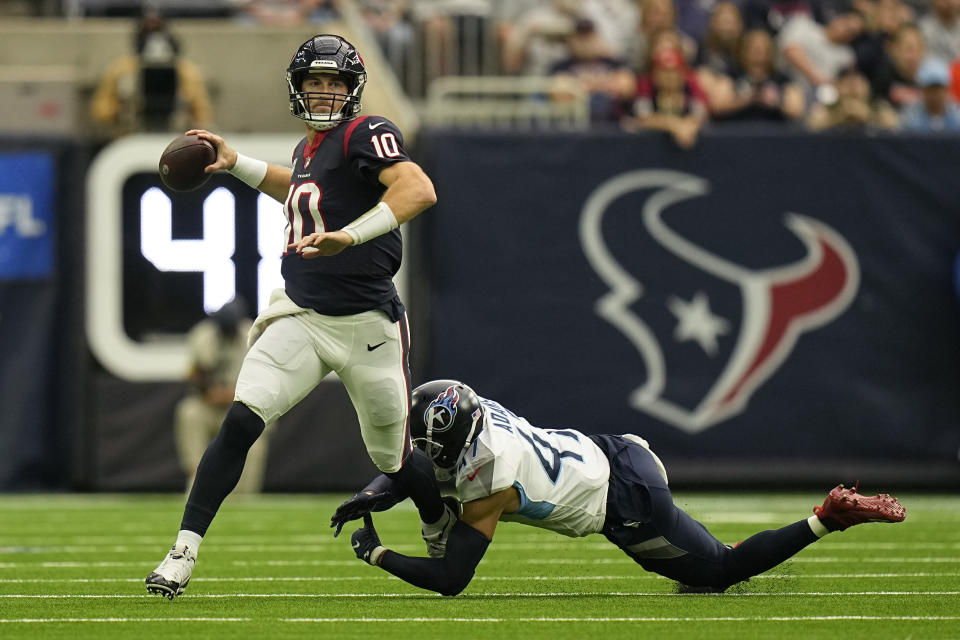 Houston Texans quarterback Davis Mills (10) passes as he is pressured by Tennessee Titans defensive back Andrew Adams (47) during the first half of an NFL football game Sunday, Oct. 30, 2022, in Houston. (AP Photo/Eric Gay)