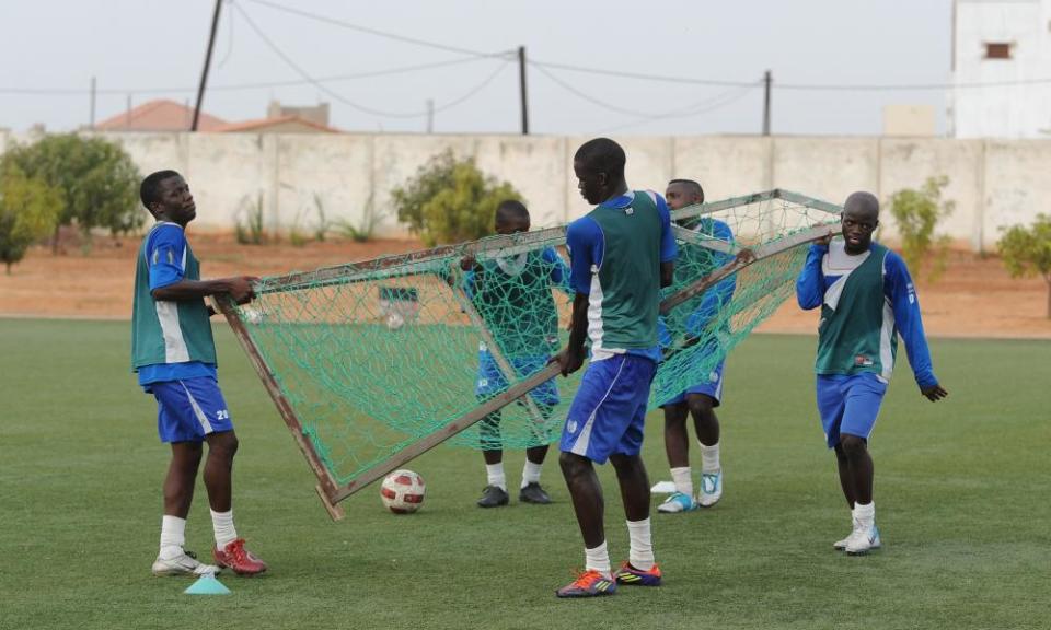 Members of the Aspire Academy carry in the goal posts after training