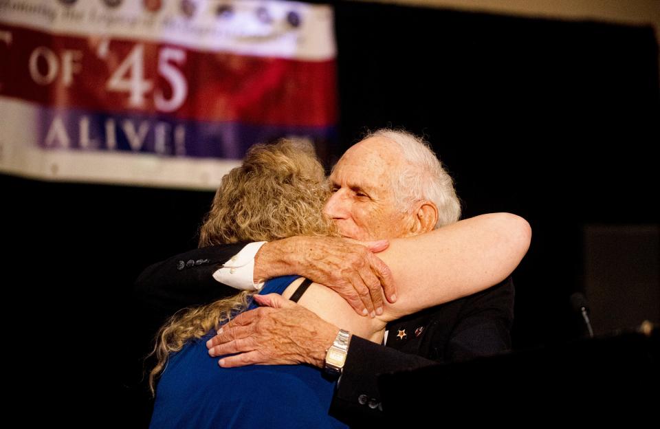 World War II veteran Robert Hilliard of Sanibel Island hugs Eryka Aptaker, Lee County chairman of Spirit of ’45, during the Spirit of ’45 Ceremony in 2022. Hilliard was a speaker at the event. This year's ceremony will be Aug. 13 at Heritage Palms Country Club in Fort Myers.