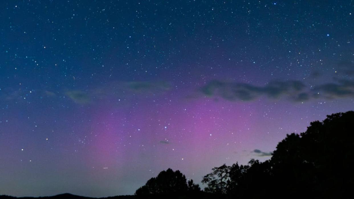 <div>The northern lights appear over a ridge in the Appalachian Mountains in Shenandoah National Park, Luray, VA, May 12, 2024. Aurora borealis and australis were visible across much of the earth after solar coronal mass ejections caused the most intense geomagnetic storm in the last 20 years. (Photo by Allison Bailey / Middle East Images / Middle East Images via AFP) (Photo by ALLISON BAILEY/Middle East Images/AFP via Getty Images)</div> <strong>((Photo by ALLISON BAILEY/Middle East Images/AFP via Getty Images))</strong>