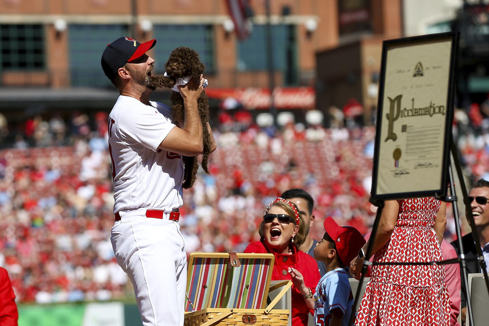 St. Louis Cardinals' Adam Wainwright is gifted a puppy as he is honored during his retirement ceremony before the Cardinals' final regular season baseball game Sunday, Oct. 1, 2023, against the Cincinnati Reds in St. Louis. (AP Photo/Scott Kane)