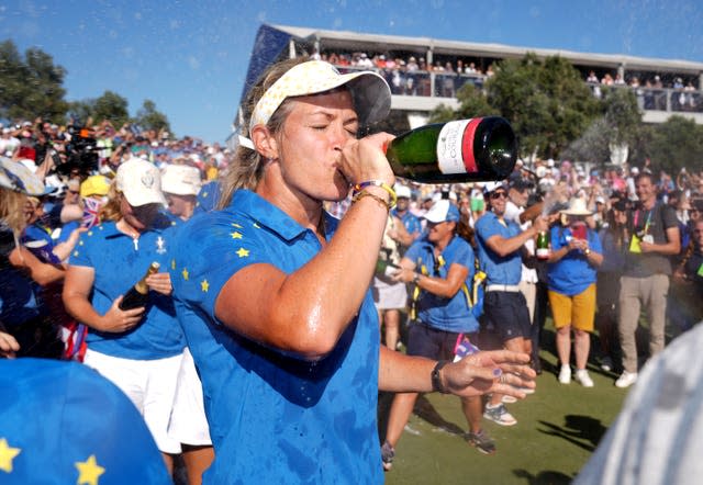 Suzann Pettersen drinks from a bottle of champagne