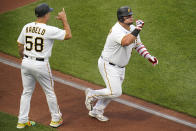 Pittsburgh Pirates' Daniel Vogelbach, right, celebrates with third base coach Mike Rabelo (58) as he rounds third after hitting a solo home run off New York Yankees starting pitcher Jameson Taillon during the second inning of a baseball game in Pittsburgh, Tuesday, July 5, 2022. (AP Photo/Gene J. Puskar)