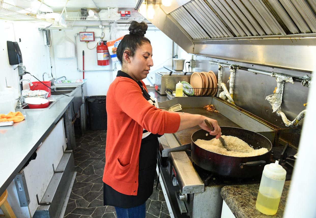 Mariela Barrera cooks rice inside the Taqueria Sanchez food truck on Friday, April 22, 2022, in Sioux Falls.
