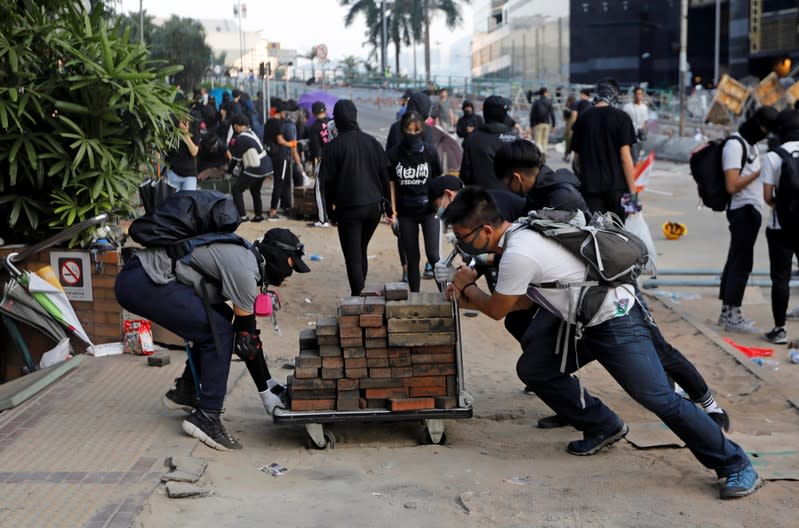 Protesters transport bricks on a cart at the Polytechnic University in Hong Kong