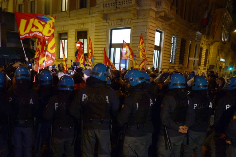 Policemen stand guard as supporters of "NO" celebrate near the Palazzo Chigi, on December 4, 2016