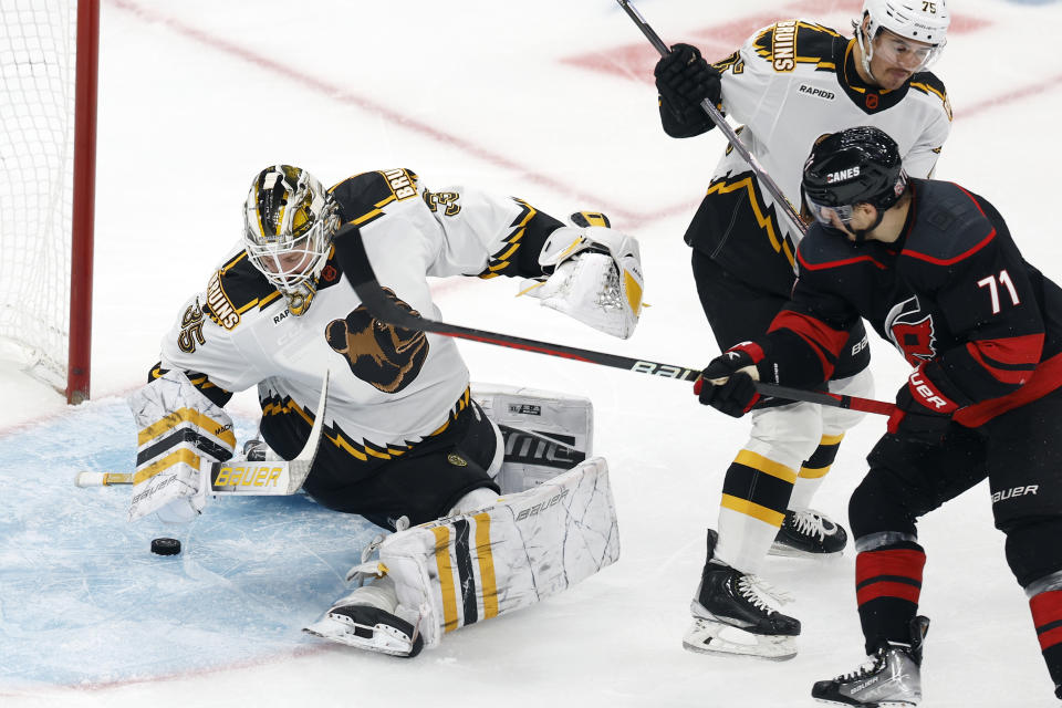 Carolina Hurricanes' Jesper Fast (71) looks for a shot as Boston Bruins' Linus Ullmark (35) covers the puck during the first period of an NHL hockey game, Friday, Nov. 25, 2022, in Boston. (AP Photo/Michael Dwyer)