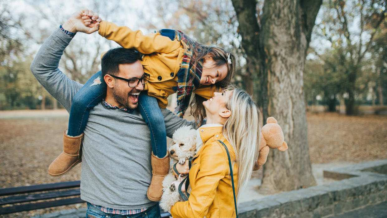 Happy family enjoying together in park.