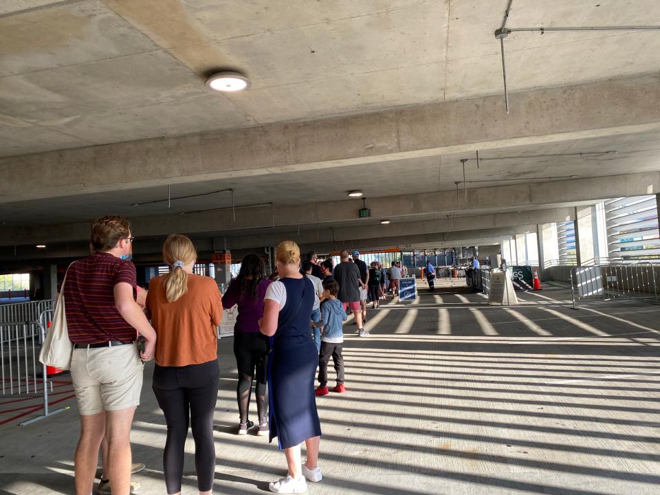 A line waits to enter Disney Springs around 8:55 in the morning on December 10, 2021.