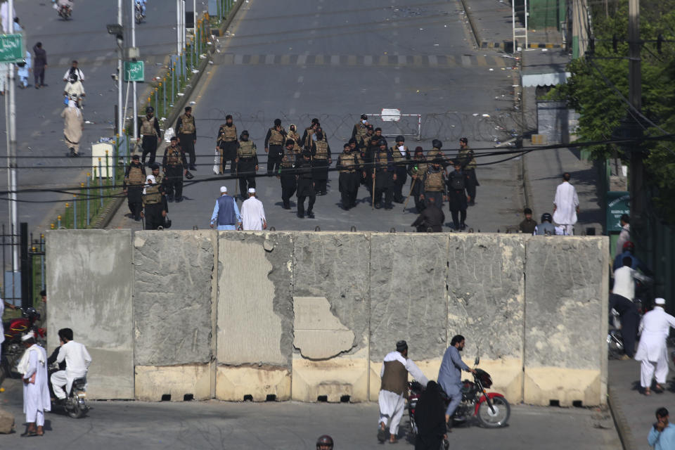 Paramilitary soldiers of Frontier Constabulary stand guard to ensure security at a barricaded road, leading to military area, in Peshawar, Pakistan, Thursday, May 11, 2023. With former Prime Minister Imran Khan in custody, Pakistani authorities on Thursday cracked down on his supporters, arresting hundreds in overnight raids and sending troops across the country to rein in the wave of violence that followed his arrest. (AP Photo/Muhammad Sajjad)