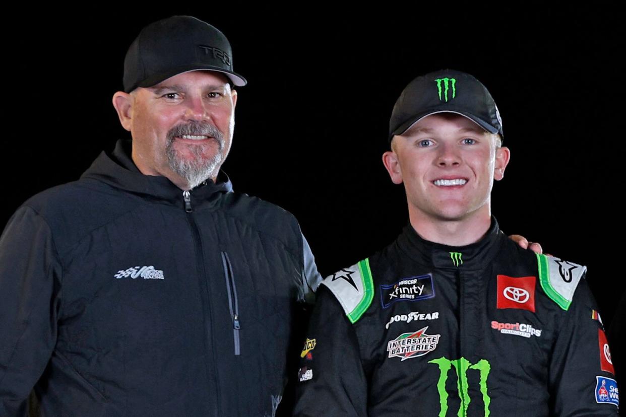 AVONDALE, ARIZONA - NOVEMBER 05: Ty Gibbs, driver of the #54 Monster Energy Toyota, poses with his father, Coy Gibbs and mother, Heather Gibbs after winning the NASCAR Xfinity Series Championship at Phoenix Raceway on November 05, 2022 in Avondale, Arizona. (Photo by Meg Oliphant/Getty Images)