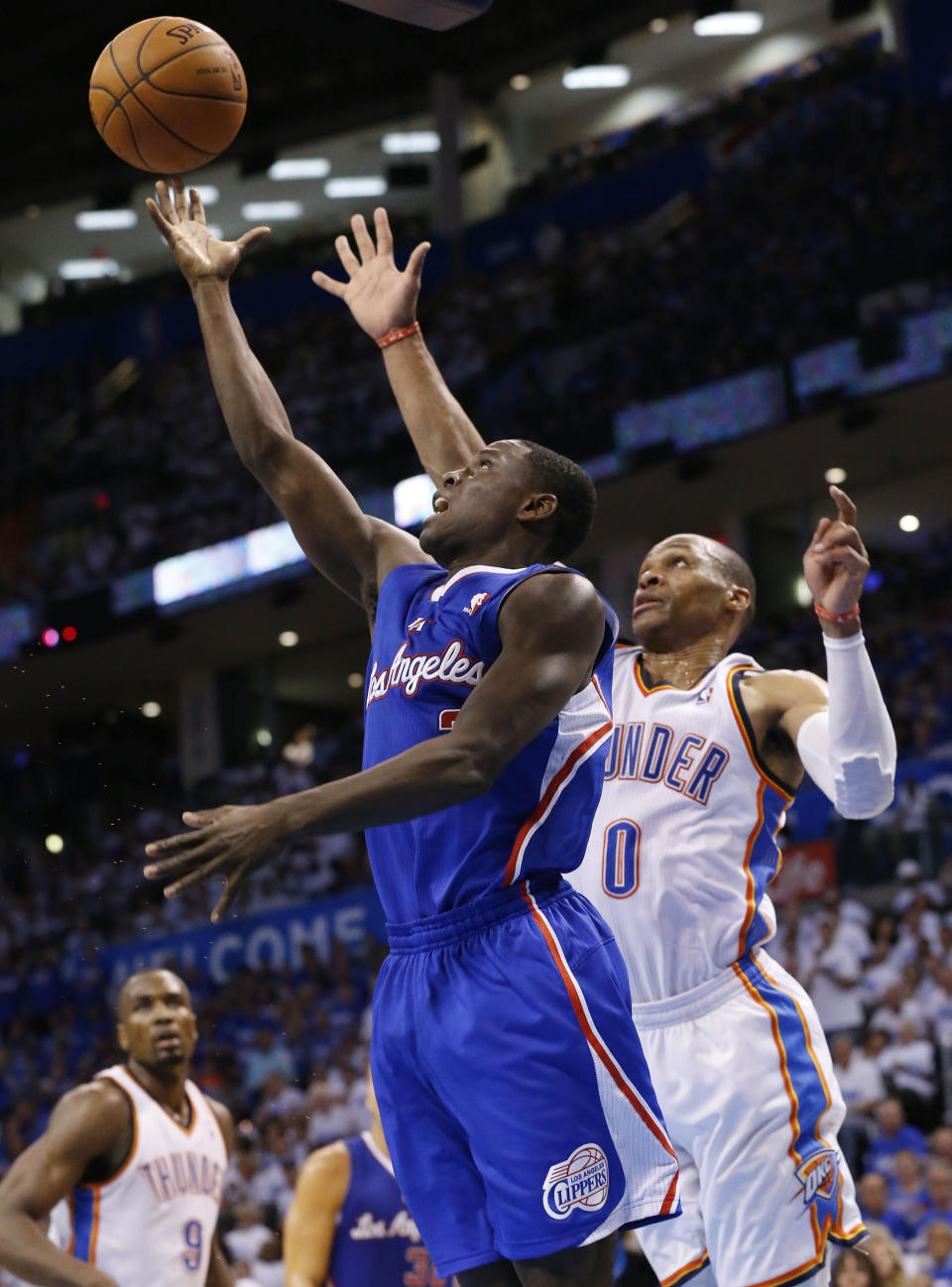 Los Angeles Clippers guard Darren Collison shoots in front of Oklahoma City Thunder guard Russell Westbrook (0) in the second quarter of Game 2 of the Western Conference semifinal NBA basketball playoff series in Oklahoma City, Wednesday, May 7, 2014. (AP Photo/Sue Ogrocki)