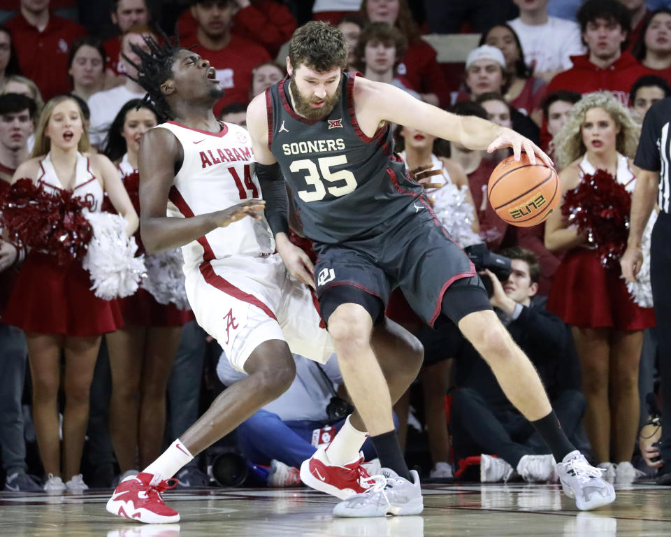 Oklahoma forward Tanner Groves (35) drives the ball against Alabama center Charles Bediako (14) during the first half of an NCAA college basketball game Saturday, Jan. 28, 2023, in Norman, Okla. (AP Photo/Garett Fisbeck)