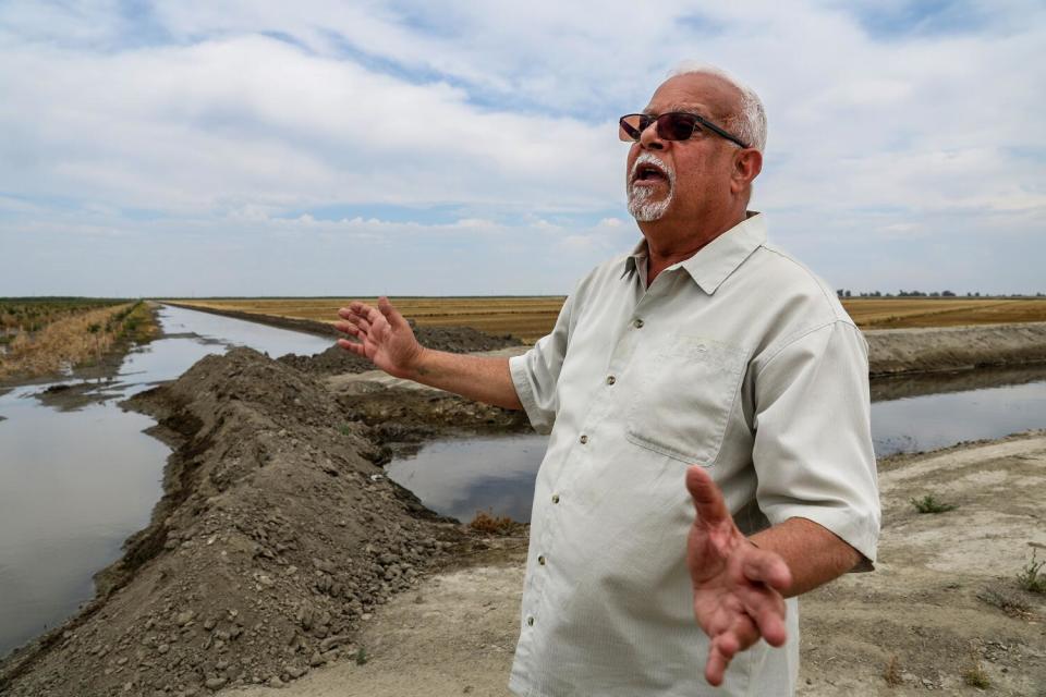 Farmer Makram Hanna stands near his flooded orchard.