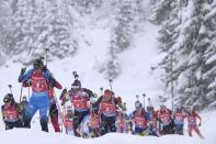 FILE - Anais Bescond, left, of France, leads the field during the women's 4x6 km relay race at the Biathlon World Cup in Hochfilzen, Austria, Dec. 11, 2021. No one nation has dominated the 2021-22 World Cup biathlon season, but several have consistently secured podium spots. On the women’s side, Norway, Sweden, Belarus and France have taken turns at the medals. (AP Photo/Matthias Schrader, File)