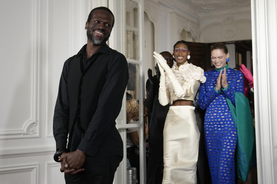 Models applaud designer Imane Ayissi after the presentation of his Haute Couture Fall/winter 2023-2024 fashion collection in Paris, Thursday, July 6, 2023. (AP Photo/Christophe Ena)