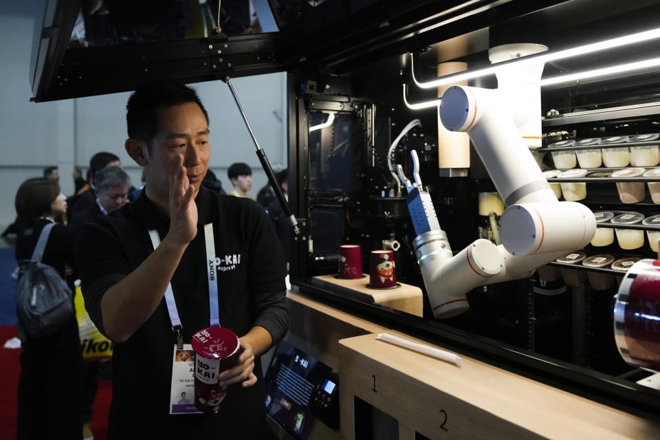 Andy Lin, Yo-Kai Express, provides a demonstration of an autonomous food vendor during the CES tech show Wednesday, Jan. 10, 2024, in Las Vegas. (AP Photo/Ryan Sun)