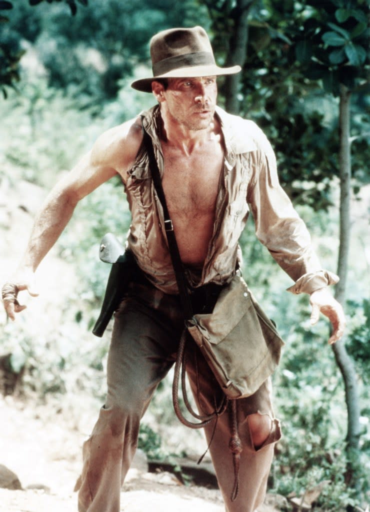 ’80s hunk Harrison Ford donned a fabric satchel while playing the titular hero Indiana Jones. ©Paramount/Courtesy Everett Collection