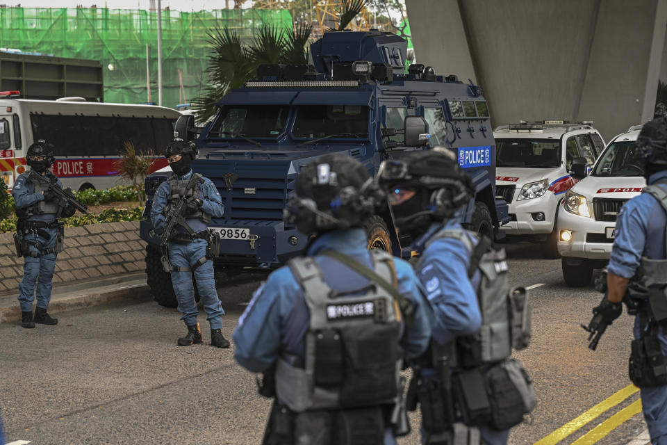Armed policemen stand watch outside the West Kowloon Magistrates' Courts, where activist publisher Jimmy Lai's trial takes place, in Hong Kong, Tuesday, Jan. 2, 2024. (AP Photo/Billy H.C. Kwok)