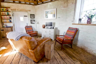 <p>There’s also a cozy living area with a wood-burning stove. (Airbnb) </p>