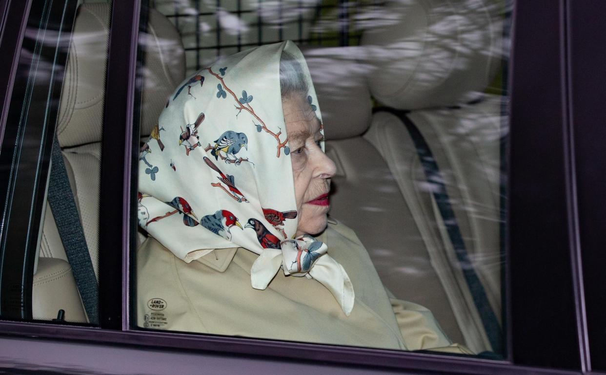 The Queen flew by helicopter from Windsor Castle on Sunday, and was photographed in her car wearing vivid lipstick and a striking headscarf featuring garden birds. - Terry Harris 