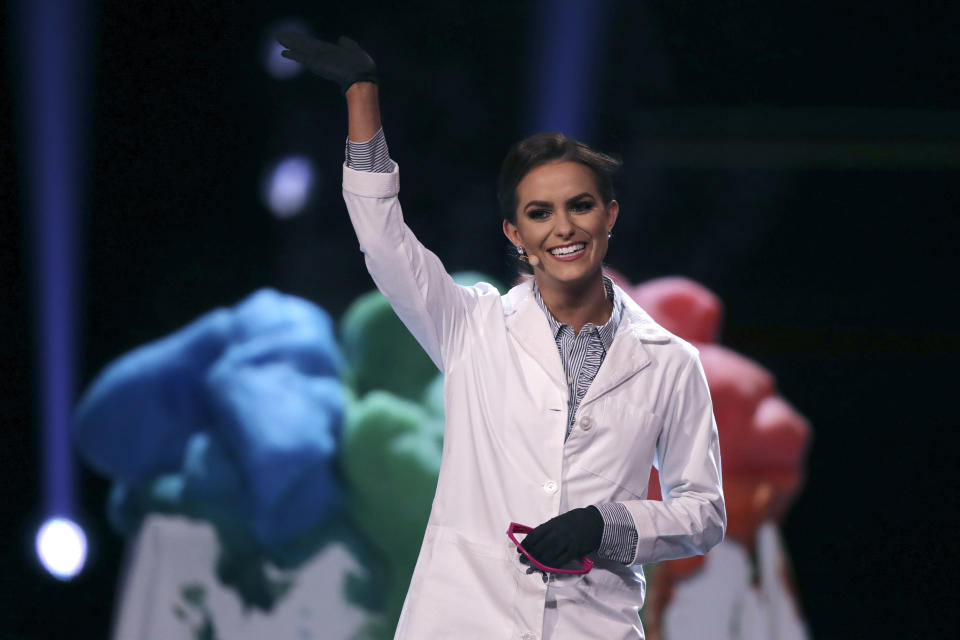 Camille Schrier, of Virginia, waves after performing a science experiment prior to winning the Miss America competition at the Mohegan Sun casino in Uncasville, Conn., Thursday, Dec. 19, 2019. (AP Photo/Charles Krupa)