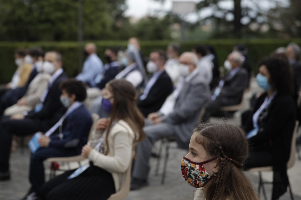 Faithful wearing face mask to prevent the spread of COVID-19 pray during a rosary lead by Pope Francis in Vatican gardens Saturday, May 30, 2020. Pope Francis is reciting a special prayer for the end of the coronavirus pandemic surrounded by a representative sampling of people on the front lines in his biggest post-lockdown gathering to date. (AP Photo/Alessandra Tarantino, pool)