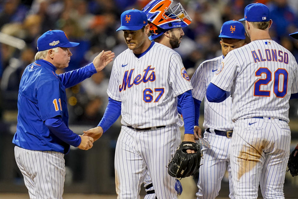 New York Mets relief pitcher Seth Lugo (67) is relieved by manager Buck Showalter, left, during the seventh inning of Game 3 of a National League wild-card baseball playoff series against the San Diego Padres, Sunday, Oct. 9, 2022, in New York. (AP Photo/Frank Franklin II)